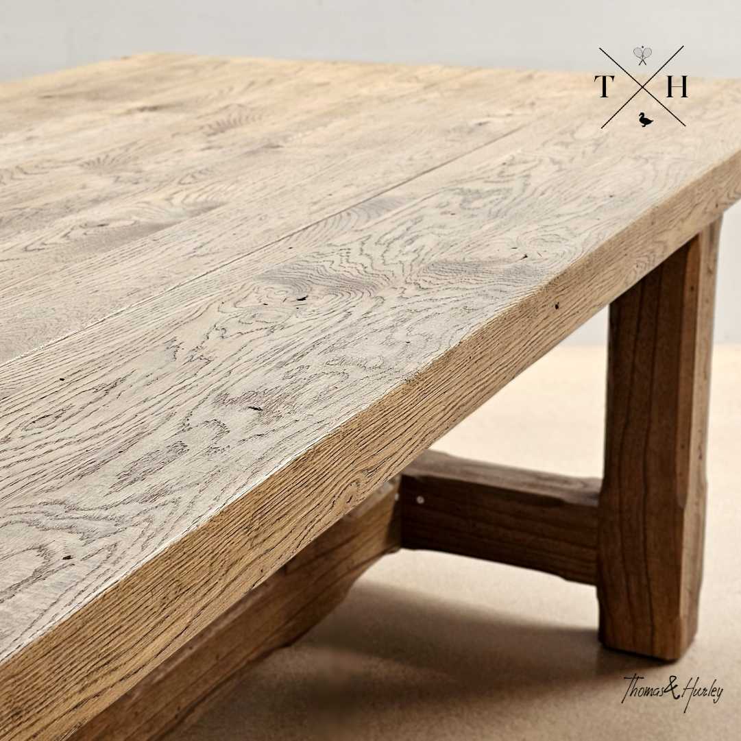 Trailbridge Canyon oak dining table close-up showing natural timber grain and rustic handcrafted leg detail